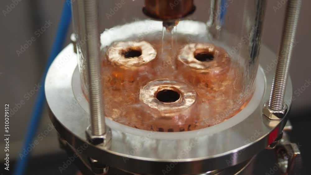 Production of homemade alcohol on a copper distillation column close-up Production of homemade alcohol on a copper distillation column close-up
