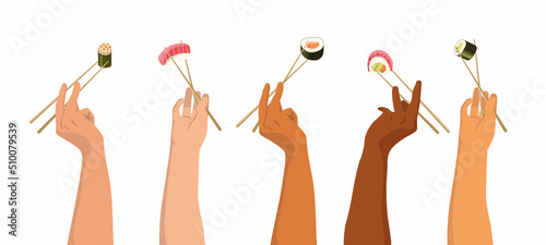 hands raised t hold in chopsticks rolls and sushi