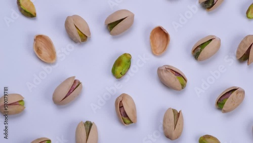 Rotating pistachios on a white background close-up photo