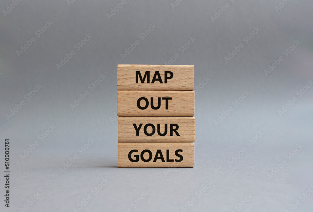 Goals symbol. Wooden blocks with words Map out your goals. Beautiful grey background. Business and 'Map out your goals' concept. Copy space Goals symbol. Wooden blocks with words Map out your goals. Beautiful grey background. Business and 'Map out your goals' concept. Copy space