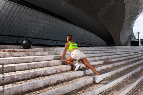 Woman in fitness wear doing workout outdoors.. Sporty girl with fit body in sportswear posing on sky background.