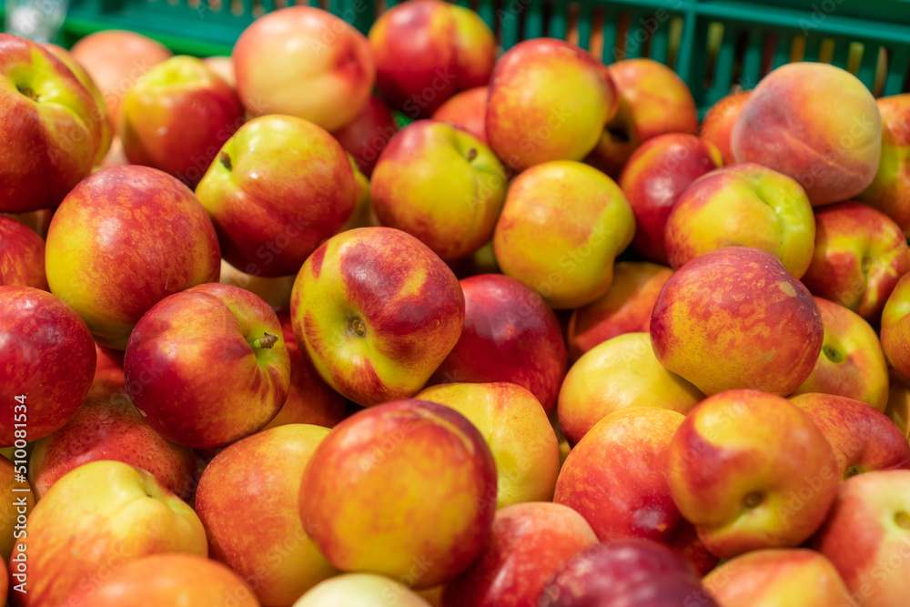 Close-up of delicious ripe red and yellow apples on the counter in the store. Sale of fruits at the market and in the supermarket