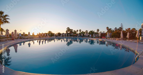 Exotic view of luxury pool area and bars in Tunisia, Africa. Swimming Pool villa, hotel with palms. Holiday concept and relax