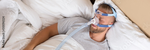 Man With Sleeping Apnea And CPAP Machine photo