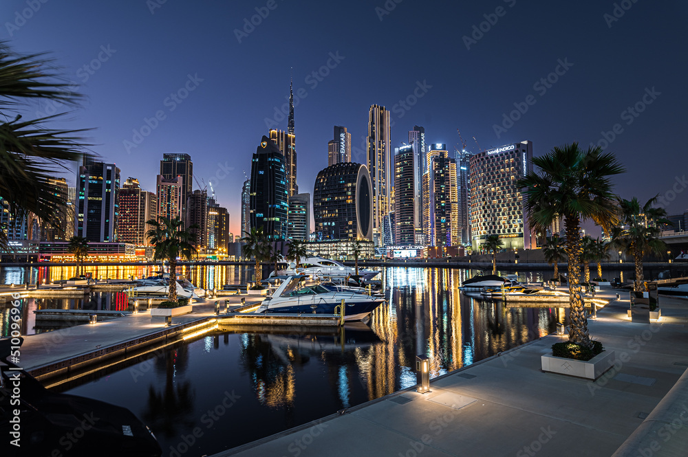 Modern glass skyscrapers in Dubai with blue sky in background. Impressive architecture of financial district and Dubai marina.