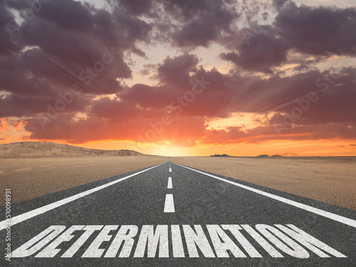 Slika na platnu Determination word written on a highway for inspirational motivation concept
