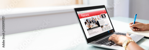 Businesswoman Checking Online News On Laptop