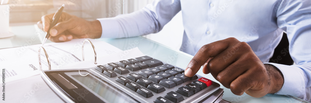 Businessman Calculating Invoice Businessman Calculating Invoice