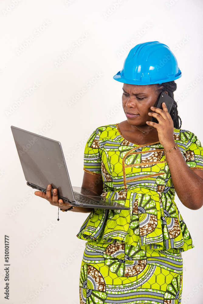 female engineer holding laptop and talking on mobile phone. female engineer holding laptop and talking on mobile phone.