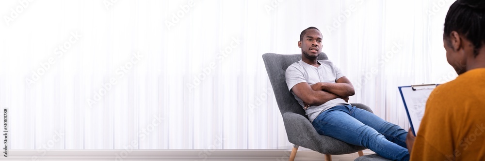 Man Sitting On Chair Near Psychologist