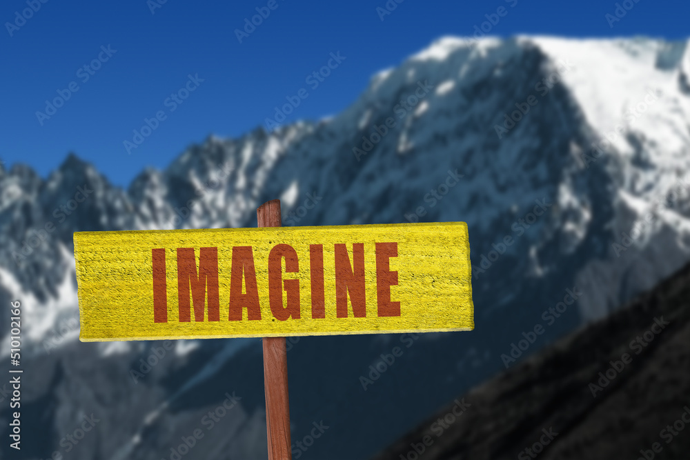 Imagine sign with snow covered mountains in the background for creative thinking concept.