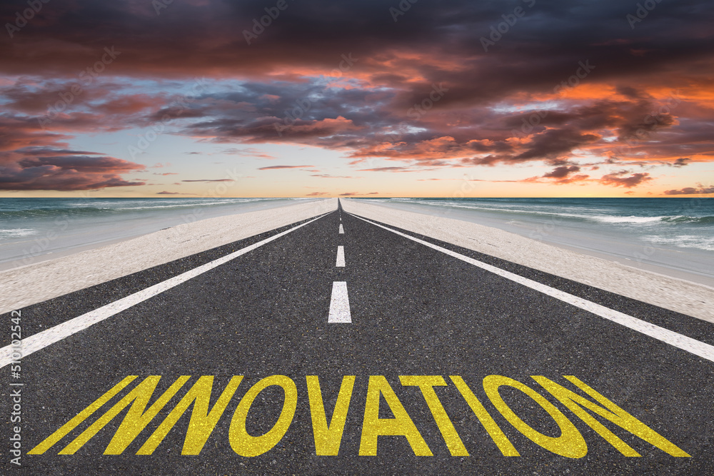 Fototapeta premium Innovation written on a beach highway leading to the future.
