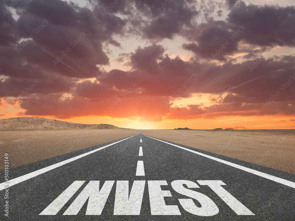 The word Invest on a beautiful highway motivation concept.