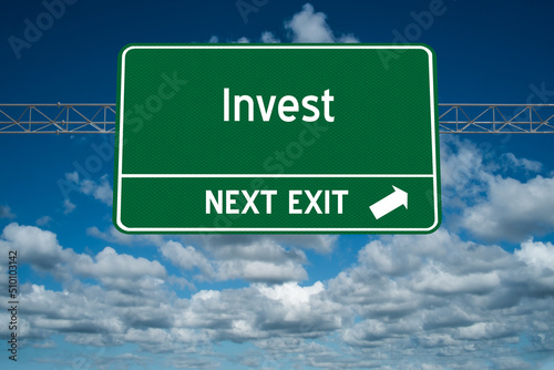 Invest highway sign on a blue sky background for motivation concept.