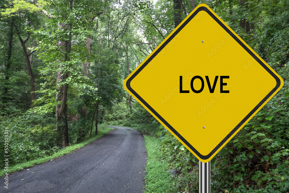 Love sign on road through the woods.  Neverending journey in love concept.