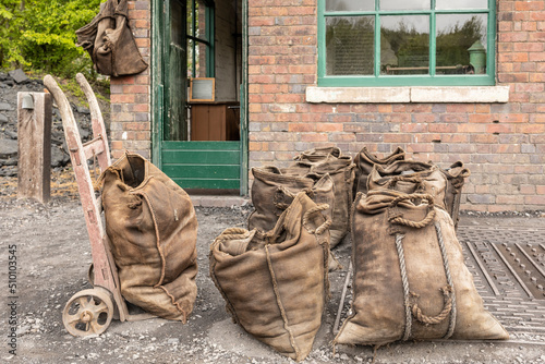 sack bags filled with coal and a vintage sack truck retro fuel delivery photo