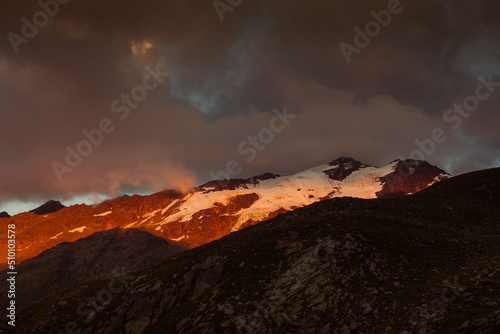 Dramatic sunset colors on peaks around the Fontana in the Palla Bianca Massif. Mountains popular with hikers and climbers. Vallelunga, Alto Adige, Italy photo