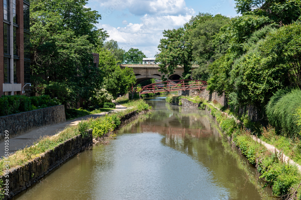 The C & O Canal runs through the Georgetown area in Washington, DC. The Francis Scott Key Bridge is in the background.