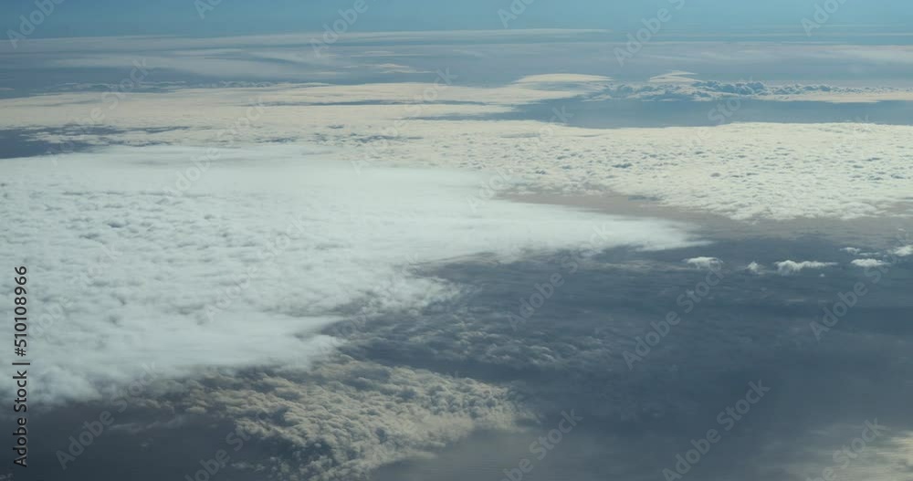 Plane flies over the clouds in the sky Plane flies over the clouds in the sky