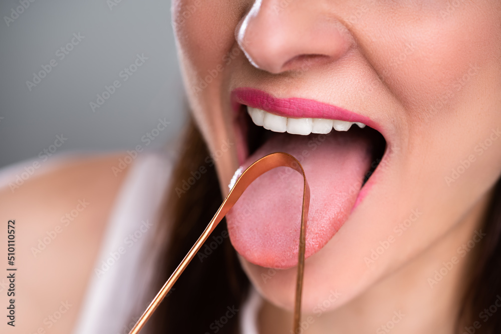 Woman Cleaning Her Tongue With Cleaner - obrazy, fototapety, plakaty 