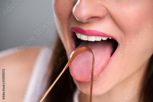 Woman Cleaning Her Tongue With Cleaner