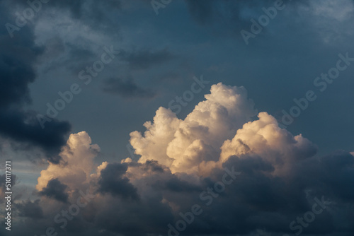 Dramatic puffy bright and dark clouds over the ocean photo