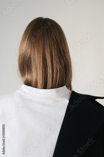 photo of a girl dressed in a white T-shirt and a jacket freely draped over one shoulder photo