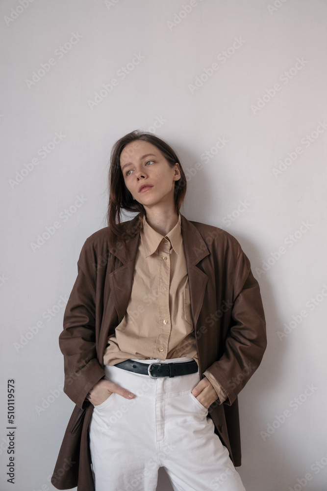 Stylish girl on a white wall background