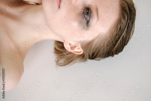 portrait of a beautiful fragile girl with a strong look close-up with unfolded shadows under the eyes