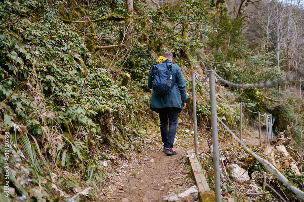 a man walking with a backpack in the woods a man walking with a backpack in the woods