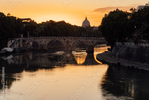 Sunset behind the Tiber river in Rome, Italy photo
