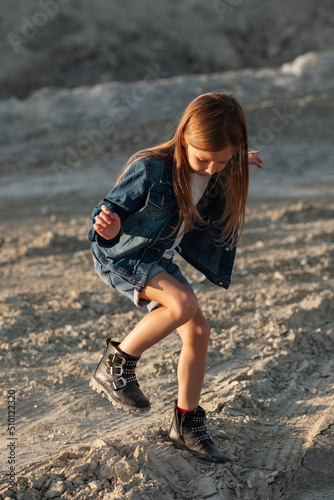 Girl dancing on sand in desert