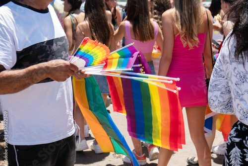 Man selling lgbt rainbow flags and fans during Gay Pride Parade