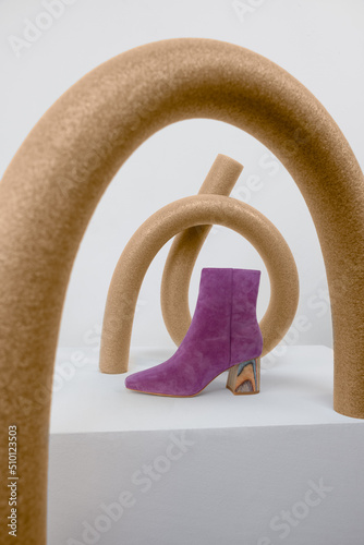 purple boot styled with brown sculptural props photo