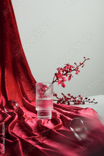 A beautiful orchid in a vase on curtain drop decoration photo