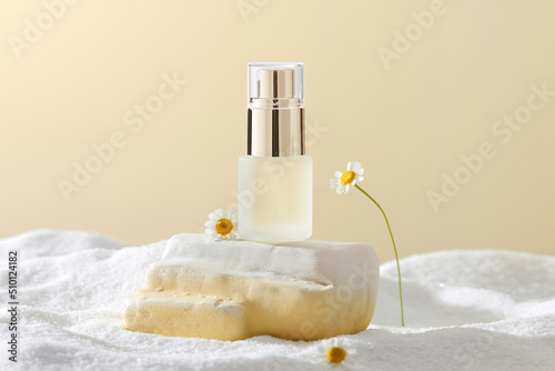 Composition with chamomile flowers and a cosmetic bottle