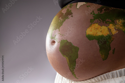 Fototapeta Naklejka Na Ścianę i Meble -  Pregnant with the map of the world drawn on her belly. Concept of pregnancy, motherhood, preparation, expectation, future and climate change.