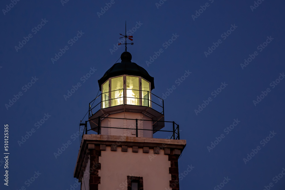 The head of lighthouse at night.