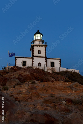 The old lighthouse on the rocky cliff at night. © 9parusnikov
