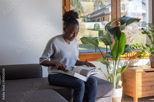 education, woman making a notes in big book at home