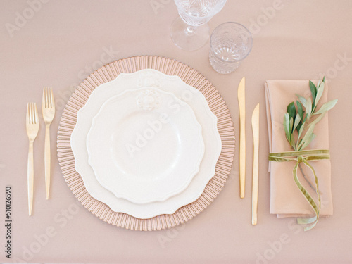 Top View Dishware And Cutlery On Beige Table photo