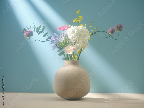 Arrangement wildflowers in vase on white table