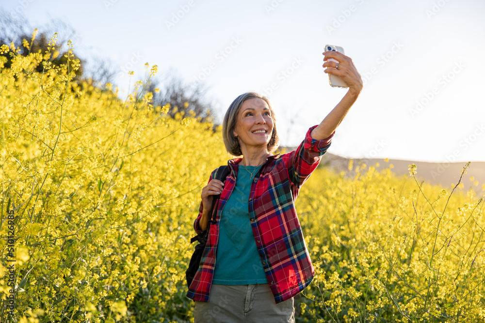 Older Woman Looks For Reception While Hiking Older Woman Looks For Reception While Hiking