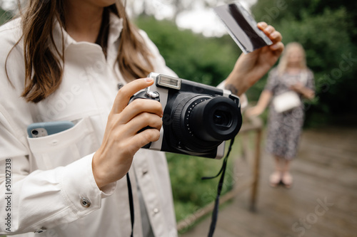 anonymous female take photo on polaroid instant camera photo