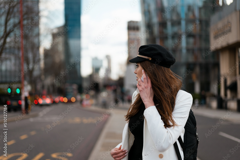 Businesswoman making a call while walking in town Businesswoman making a call while walking in town