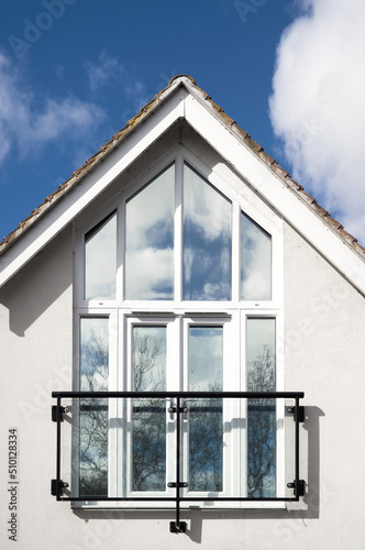 Modern home with attic style window and Juliet Balcony