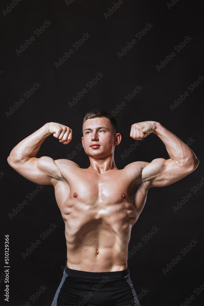 Powerful male model doing stomach vacuum exercise in studio Powerful male model doing stomach vacuum exercise in studio