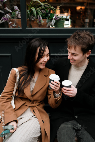 A couple drinks a coffee and has fun photo