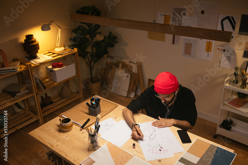 Man creating sketch on illuminated table photo