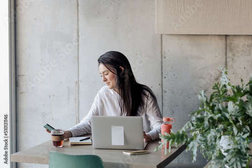 Young Girl Working With Computer in a Cafe